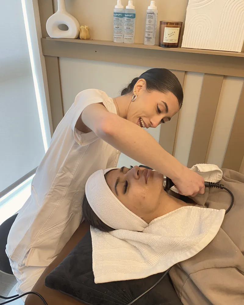 A skin specialist giving a facial treatment