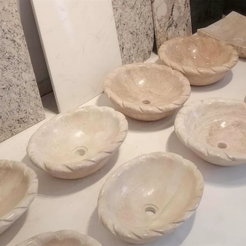 Handmade ceramic bowls drying on a pottery table