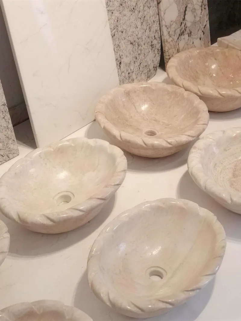 Handmade ceramic bowls drying on a pottery table