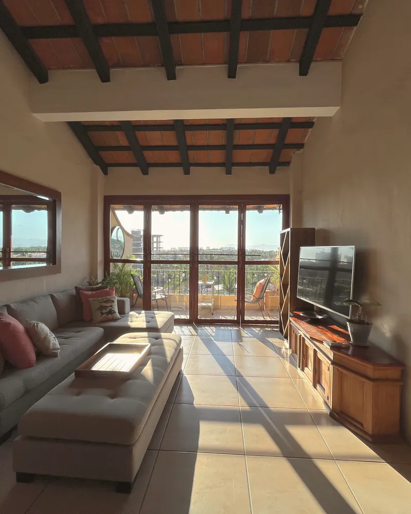 A sunlit Mediterranean-style room opening onto the view